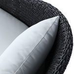 Close-up of textured wicker pattern on rear footed leg of chair