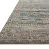 Low side angle showing rug’s thin profile and detailed border design with fringed edge