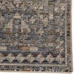 Close-up of intricate border with dark blue triangle and diamond shapes in worn effect