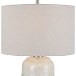 Close-up view of light gray linen drum lampshade with smooth texture and subtle weave