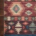 Corner of Zion Fiesta rug on wood floor highlighting dense pattern and stitched edges