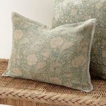 Pascaline Pillow displayed on woven rattan surface emphasizing natural fibers and piped edges