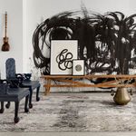 Rug in an artistic interior with bold black brushstroke wall art and eclectic furniture