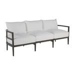 Outdoor sofa with slate gray aluminum frame and plush white cushions displayed on angle