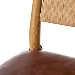 Detail of leather cushion tie knot securing cushion to wood frame on chair back