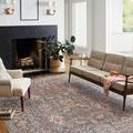 Living room styled scene with Rosemarie rug under neutral beige couch and cream armchair facing window