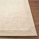 Detailed close-up of the rug’s corner showing the thick pile and distinct layered border design.