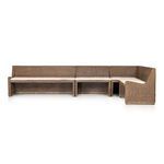 Angled side view showing the full height armrest and woven rattan frame base