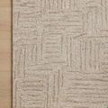 Close-up of the corner of Polly Smoke/Sand rug on a light wood floor showing detailed pile texture.