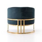 Rear side angle of Corbin Chair illustrating velvet upholstery with brass frame wraparound