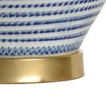 Close-up of brass lamp base showing smooth metallic finish