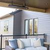 Montauk sofa with decorative pillows on covered deck under ceiling heater and adjacent gray siding