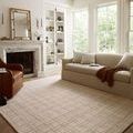 Polly Khaki / Sand Rug styled in a bright living room with beige sofa and fireplace