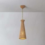 Tallman Pendant illuminated from inside, showing warm light glowing through wood bead shade