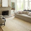 Santa Fe Rug styled in bright living room with beige sofa and fireplace