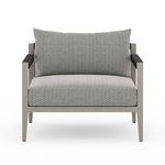 Direct front view focused on the chair’s straight lines and textured grey cushions