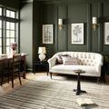 Humphrey Natural Moss rug in living room with dark green walls and white tufted sofa