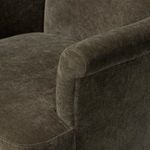 Detailed close-up of the rolled armrest joint with seat on Camellia Swivel Chair.
