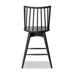 Close-up of black wire-brushed oak leg with metal floor protector tip