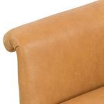 Close-up showing tapered leather armrest with fine grain and stitching