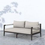 Sherwood sofa outdoor setting with stone grey cushions surrounded by garden plants