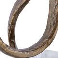 Close-up texture of the rough antique brass finish on the ribbon base of the Ruban Accent Table