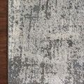 Corner view highlighting the muted charcoal pattern against a dark wood floor