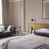 Bedroom scene showing Rustic Weft Wallpaper on walls with decorative floral border and neutral furnishings