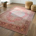 Rug styled in bright room with two woven poufs on wood flooring and natural light