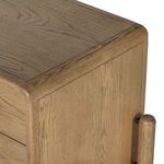Detail of drawer handle combining wood and black metal hardware