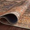 Rolled edge of Loren Plum / Multi rug showing thickness and soft polyester textured base