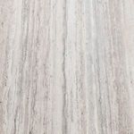 Top-down view of the light, stone-textured laminate tabletop surface