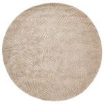 Overhead view of round beige rug showing full abstract labyrinth pattern and soft texture