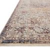 Close-up side angle showing thin pile height and fringed edge of the rug