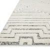 Angled close-up showing pile height and detailed geometric pattern edge of Hagen White / Sky Rug