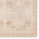 Zoomed-in view of Southwestern medallion pattern and fine border detailing on tan and cream rug