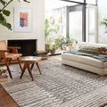 Yeshaia Blush Taupe Rug styled in bright living room with natural light, furniture, and plants