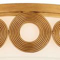 Macro shot focused on medium concentric circle brass detail in warm antique brass finish