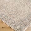 Close-up of Maria Brown/Ivory Elena rug corner showing floral medallion pattern and texture on light wood flooring