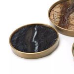 Close-up of smallest round brass tray with black marble inlay and white streak detail