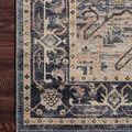 Corner close-up focusing on navy floral border and intricate patterned edge on wooden floor.