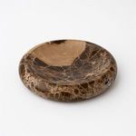 Side angle showing shallow depth and curved edges of the polished brown marble tray