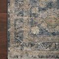 Close-up of Gaia Denim rug edge on dark wood floor highlighting intricate pattern details