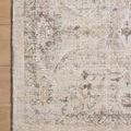 Close-up corner of Marcella rug displaying intricate screen-printed floral details on wooden floor