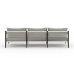 Rear view of Sherwood sofa showing dark frame with vertical rope weaving between aluminum supports