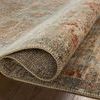 Edge view with rug slightly rolled, revealing thick weave and backside texture