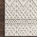 Corner view on dark wood flooring highlighting detailed geometric weave and border pattern