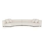 Angled view of sectional’s crescent shape emphasizing smooth curves and padded cushions