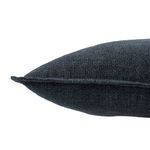 Close-up side profile of dark blue linen pillow showing textured fabric and flange edge
