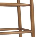 Detail of rounded tapered teak legs connected with smooth wooden stretchers